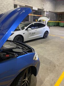 A professional performing a roadworthy inspection on a car in Brisbane, QLD