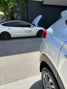 Technician performing detailed vehicle inspection on Brisbane